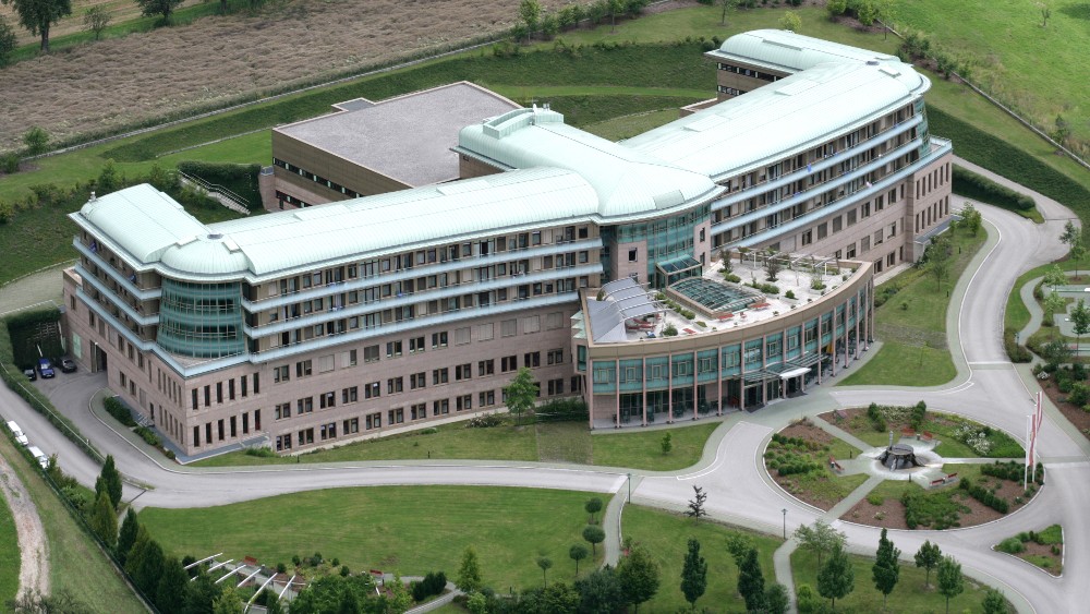 Blick von oben auf das Reha-Zentrum Bad Schallerbach mit Bäumen und Feldern im Hintergrund